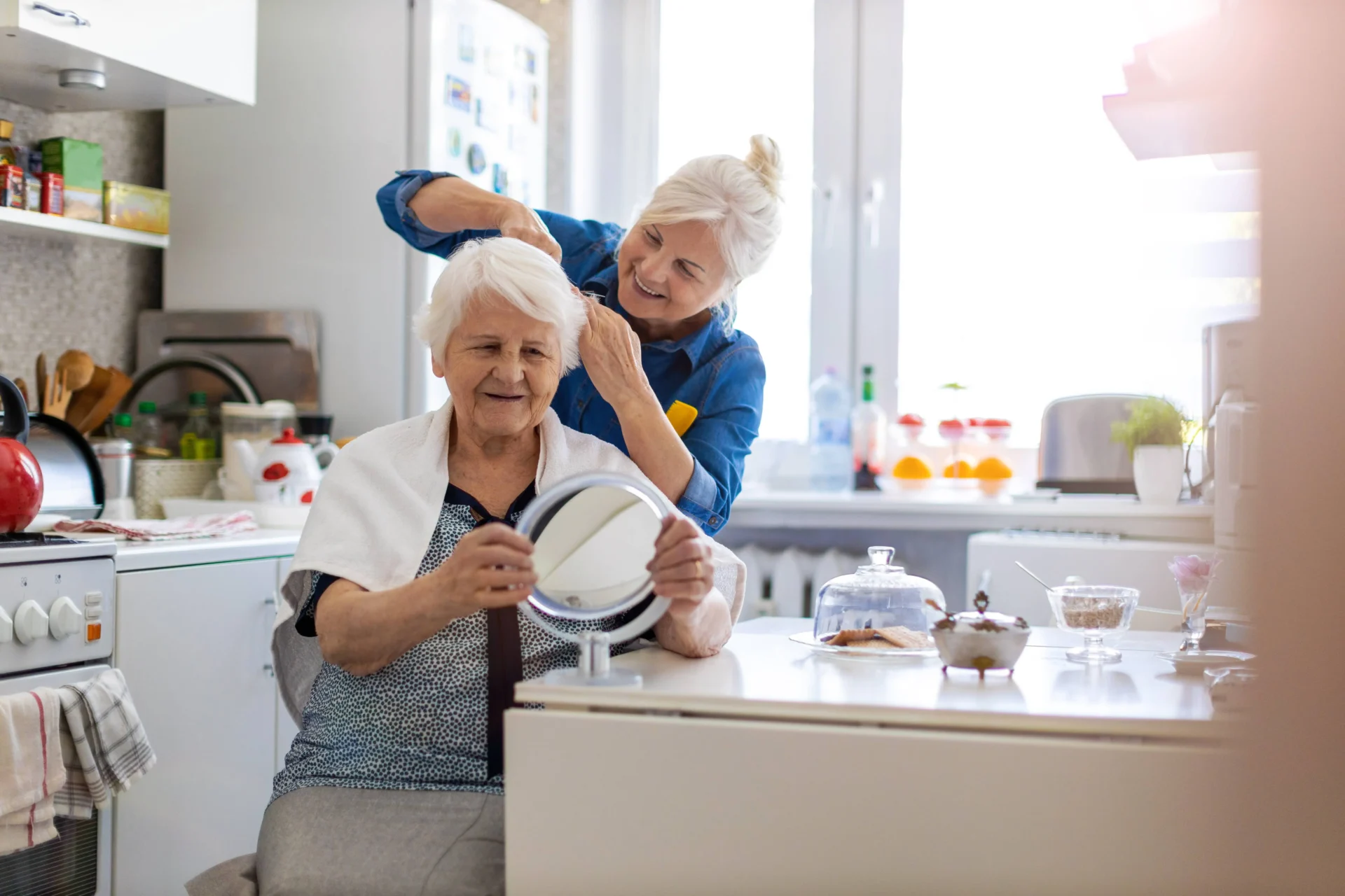 a caregiver combing a senior's hair