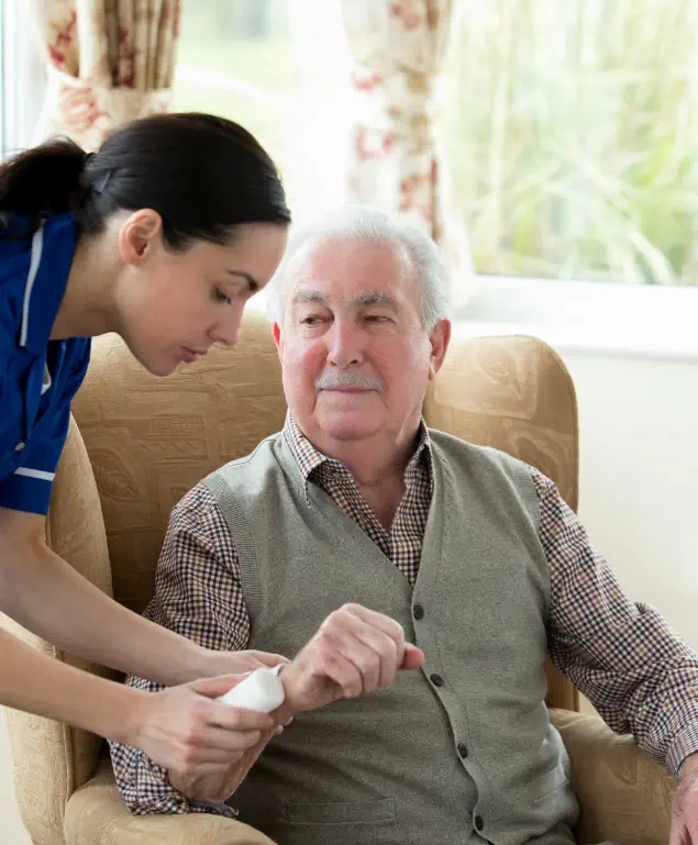A caregiver is assisting an elderly individual with personal care