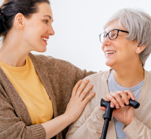 A woman speaks with an elderly woman, showcasing qualified and diverse caregivers in chicago area